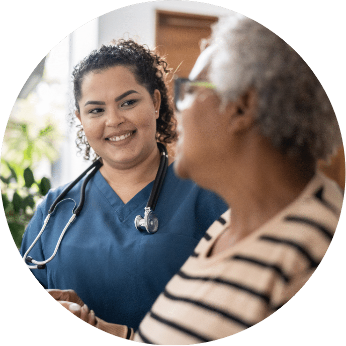 Smiling Caretaker Talking to Patient