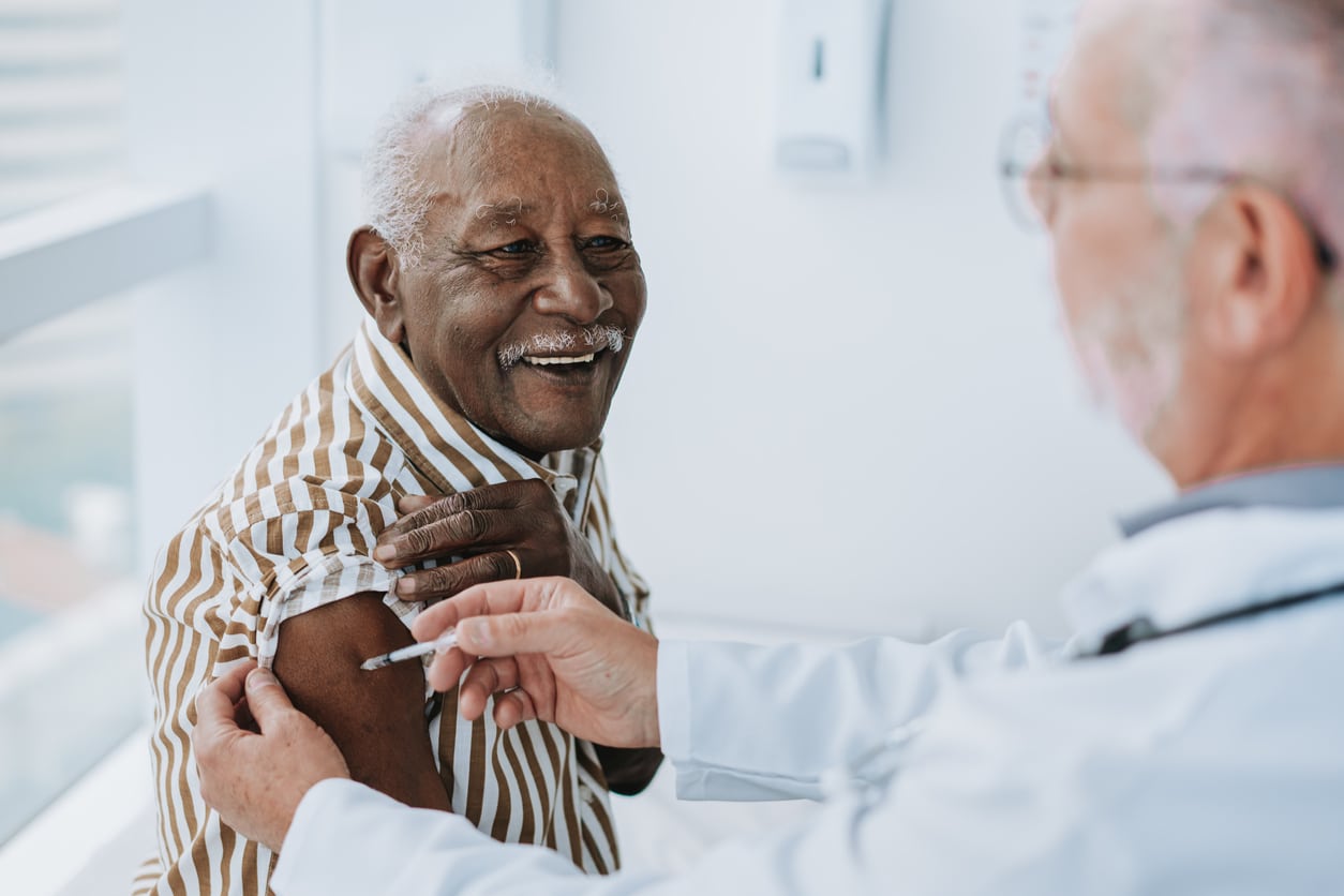 elderly patient sitting with a doctor after choosing a healthcare provider