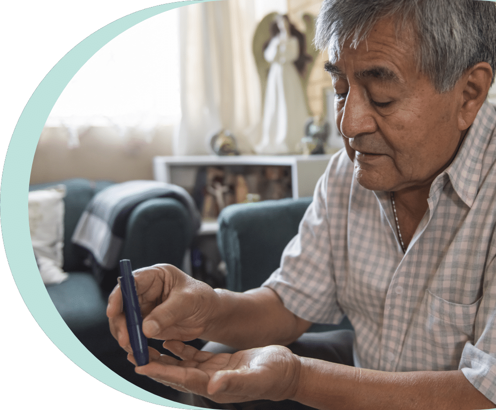 elder man pricking his finger while having diabetes for seniors