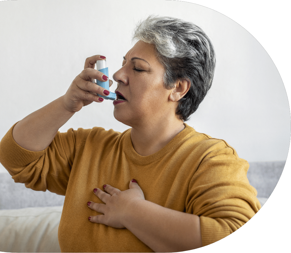 senior woman with COPD using an inhaler