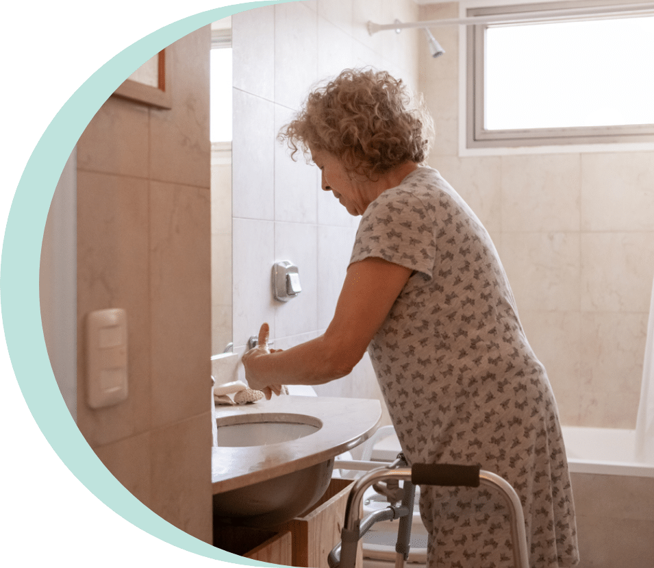 Elderly woman washing her hands after suffering from urinary incontinence in seniors