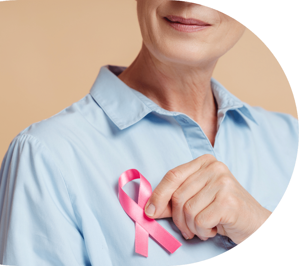 Woman holding a pin that represents breast cancer in seniors