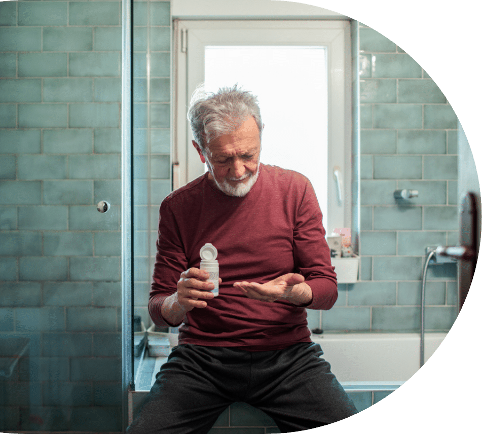 Older man sitting in his bathroom while taking gabapentin