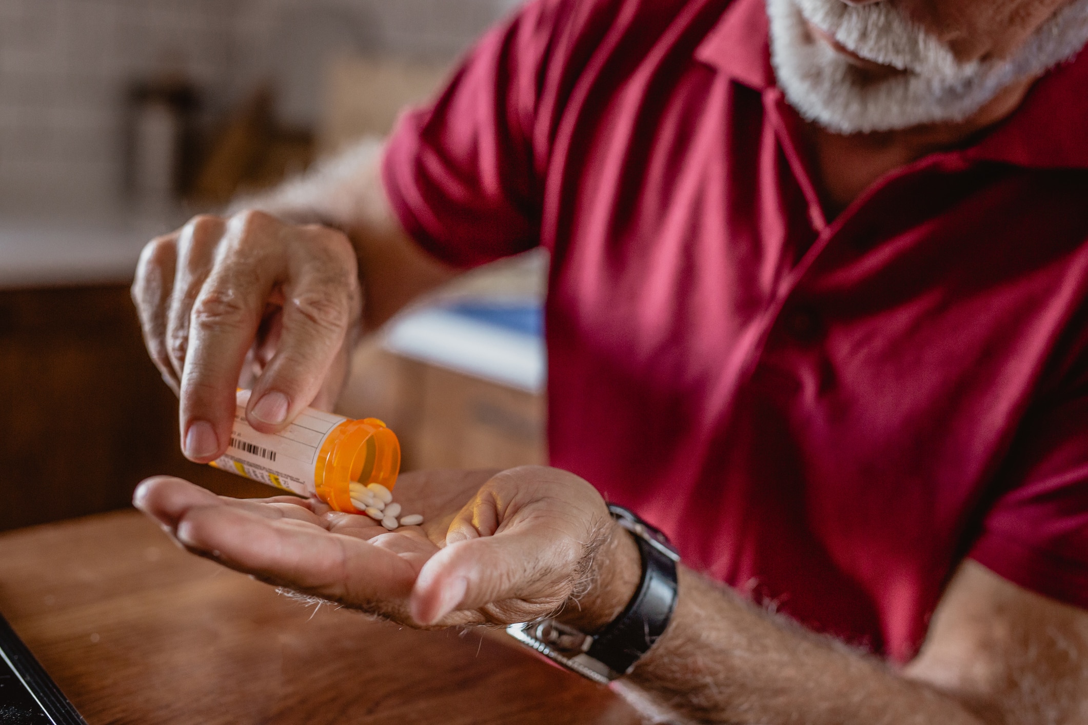 Older man taking prescription medications and in need of medication management tips for older adults