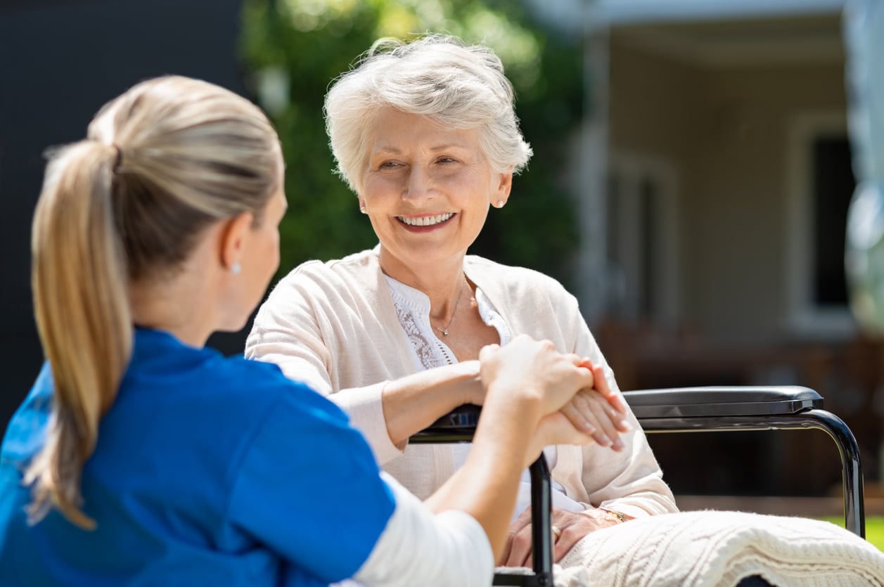 older woman experiencing holistic primary care for seniors and smiling