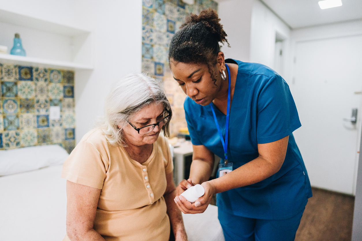 primary care physician showing older lady how to prevent medication errors