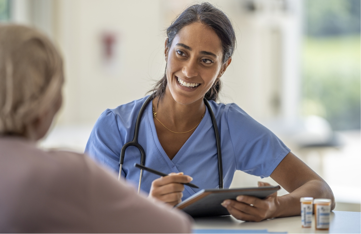 Young female provider talking to a patient and smiling