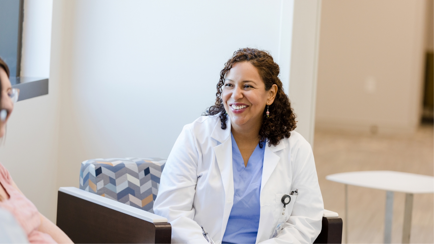 Young female provider talking to a patient and smiling