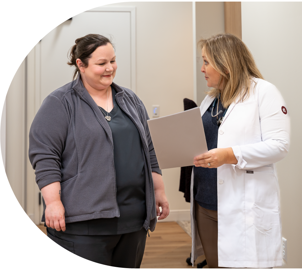 Nurse Practitioner discussing a patient chart with Medical Assistant