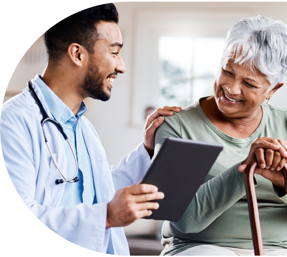 Senior woman smiling with her clinician at a primary care clinic