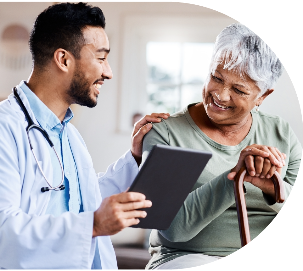 Senior woman smiling with her clinican at a primary care clinic